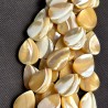 Strand of beige and white token pearl pearl